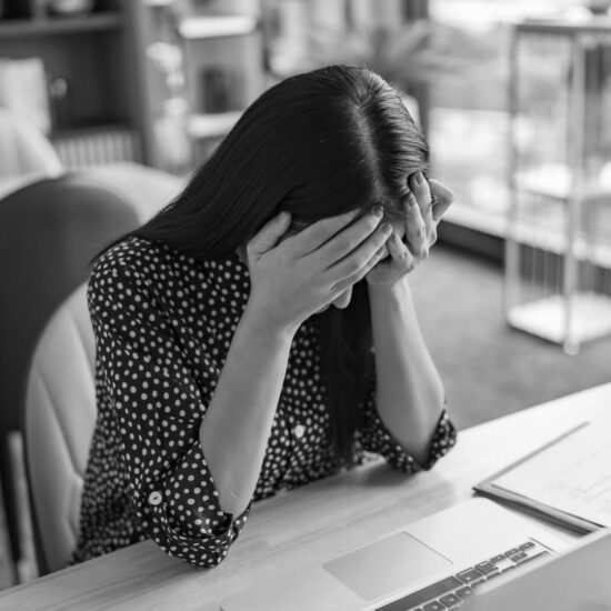 stressed professional woman sitting in front of computer