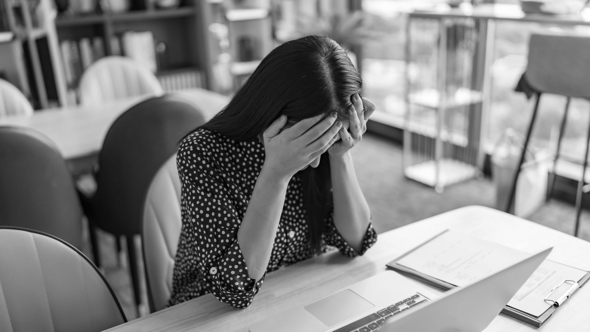 stressed professional woman sitting in front of computer
